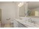 Bathroom features a dual sink vanity, a large mirror, and updated fixtures at 7603 W Oraibi Dr, Glendale, AZ 85308