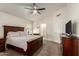 Spacious bedroom features a ceiling fan, soft carpet, and a full sized bed at 7603 W Oraibi Dr, Glendale, AZ 85308