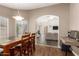 Dining area with wood table and views of the living room at 7603 W Oraibi Dr, Glendale, AZ 85308