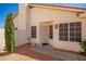 Front entrance featuring a security door, window and desert landscaping at 7603 W Oraibi Dr, Glendale, AZ 85308