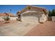 Single-story home with a two-car garage and low-maintenance desert landscaping in the front yard at 7603 W Oraibi Dr, Glendale, AZ 85308