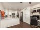 Modern kitchen featuring white cabinets, stainless steel appliances, and a spacious breakfast bar at 7603 W Oraibi Dr, Glendale, AZ 85308