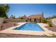 An inviting backyard pool with a covered patio area perfect for outdoor relaxation and entertainment at 7603 W Oraibi Dr, Glendale, AZ 85308