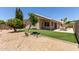 View of the backyard featuring a covered patio, artificial grass, and desert landscaping at 9559 W Runion Dr, Peoria, AZ 85382