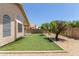 Backyard offering artificial turf and mature landscaping in a low maintenance yard at 9559 W Runion Dr, Peoria, AZ 85382