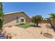 Backyard featuring low maintenance desert landscaping, turf, and covered patio at 9559 W Runion Dr, Peoria, AZ 85382