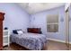 Comfortable bedroom features wood floors, vaulted ceilings, and ample natural light from the window at 9559 W Runion Dr, Peoria, AZ 85382