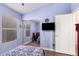 Bedroom featuring hardwood floors, mirrored closet, and a wall-mounted TV at 9559 W Runion Dr, Peoria, AZ 85382