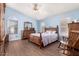 Spacious bedroom with light blue walls, wood flooring, and ample natural light from multiple windows at 9559 W Runion Dr, Peoria, AZ 85382