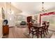 Dining room featuring vaulted ceilings, wood floors, lots of natural light and seating for six at 9559 W Runion Dr, Peoria, AZ 85382