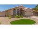 Charming single-story home featuring a well-maintained front yard and a two-car garage at 9559 W Runion Dr, Peoria, AZ 85382
