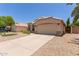 Exterior view of a home showcasing a well-manicured yard and wide driveway at 9559 W Runion Dr, Peoria, AZ 85382