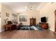 Bright living room boasts wood floors and natural light with comfortable furnishings and stylish decor at 9559 W Runion Dr, Peoria, AZ 85382