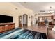 Open-concept living room with wood flooring that flows seamlessly into the adjacent eat-in kitchen at 9559 W Runion Dr, Peoria, AZ 85382