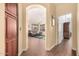 View of the living room through an archway with hardwood floors and gray sofa at 9559 W Runion Dr, Peoria, AZ 85382