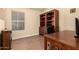 Office space with built-in shelving, natural light, and wood-look flooring at 9559 W Runion Dr, Peoria, AZ 85382