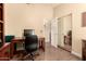 Home office including desk, office chair, and closet with sliding mirrored doors at 9559 W Runion Dr, Peoria, AZ 85382