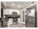 Modern kitchen with stainless steel appliances, tile backsplash, and plenty of cabinet storage at 11122 W Desert Butte Dr, Sun City, AZ 85351