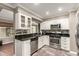 Well-equipped kitchen featuring stainless steel appliances, sleek black countertops, and ample cabinet space at 11122 W Desert Butte Dr, Sun City, AZ 85351