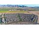 Expansive aerial view of a new residential community with houses, farms, and mountain backdrop at 12122 W Levi Dr, Avondale, AZ 85323