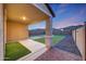 Covered patio showcasing the backyard's design, including grass and pavers at 12122 W Levi Dr, Avondale, AZ 85323
