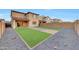 Spacious backyard with artificial turf, pavers, and low-maintenance landscaping, great for outdoor entertaining at 12122 W Levi Dr, Avondale, AZ 85323