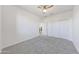 Bright bedroom with a ceiling fan, carpet flooring and large closet at 12122 W Levi Dr, Avondale, AZ 85323
