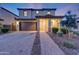 Well-maintained two-story home boasts a welcoming facade with stone accents and a neatly landscaped front yard at 12122 W Levi Dr, Avondale, AZ 85323