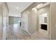 Bright and open hallway leading to a well-lit living area and adjacent bathroom, showcasing modern design at 12122 W Levi Dr, Avondale, AZ 85323