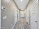 Bright hallway showcasing modern flooring and neutral walls, connecting various rooms within the home seamlessly at 12122 W Levi Dr, Avondale, AZ 85323