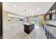 Bright kitchen boasts a large island, pendant lights, stainless appliances, and opens to the living area at 12122 W Levi Dr, Avondale, AZ 85323