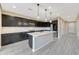 Modern kitchen featuring an island with seating, sleek countertops, and stylish cabinetry, enhancing the home at 12122 W Levi Dr, Avondale, AZ 85323