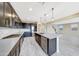 Stylish kitchen includes a kitchen island with seating, stainless steel appliances, and dark cabinets at 12122 W Levi Dr, Avondale, AZ 85323