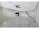 Open-concept living area with tile flooring that connects to a modern kitchen and staircase at 12122 W Levi Dr, Avondale, AZ 85323
