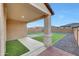 Covered patio looks out onto an expansive backyard with artificial turf and rock accents at 12122 W Levi Dr, Avondale, AZ 85323