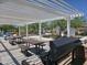 Shaded picnic area with charcoal grill, tables, and playground in background at 12122 W Levi Dr, Avondale, AZ 85323