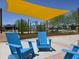 Community playground features shade and Adirondack chairs for relaxing at 12122 W Levi Dr, Avondale, AZ 85323