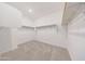 Spacious walk-in closet with carpeted floor and wooden shelving at 12122 W Levi Dr, Avondale, AZ 85323