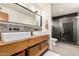 Stylish bathroom with double sinks, wood countertop, decorative tile, and glass enclosed shower at 1353 W Kiowa Ave, Mesa, AZ 85202