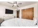 Bright bedroom with a ceiling fan, dresser, and large closet at 1353 W Kiowa Ave, Mesa, AZ 85202