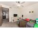 Bedroom with an adjacent sink and tv with carpeted floors at 1353 W Kiowa Ave, Mesa, AZ 85202