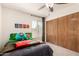 Bright bedroom featuring a ceiling fan, closet and fun decorations at 1353 W Kiowa Ave, Mesa, AZ 85202