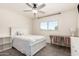 Cozy bedroom with neutral tones, a ceiling fan, and a quaint writing desk at 1353 W Kiowa Ave, Mesa, AZ 85202