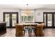 Bright dining area with wood table, wicker chairs, and views of the pool through the large doors at 1353 W Kiowa Ave, Mesa, AZ 85202