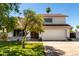 Charming two-story home boasts a well-maintained lawn, mature trees, and a two-car garage at 1353 W Kiowa Ave, Mesa, AZ 85202