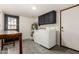 Laundry room with black cabinets above and door leading outside at 1353 W Kiowa Ave, Mesa, AZ 85202