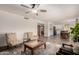 Open living room with comfortable seating, ceiling fan, and view into the kitchen and dining areas at 1353 W Kiowa Ave, Mesa, AZ 85202