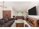 Bright living room featuring vaulted ceilings, a large window, and a contemporary entertainment center at 1353 W Kiowa Ave, Mesa, AZ 85202