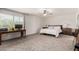Bright main bedroom with a large window, ceiling fan, and neutral carpet at 1353 W Kiowa Ave, Mesa, AZ 85202