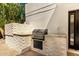 A built-in outdoor grill with stone accents, ideal for barbecues and outdoor cooking at 1353 W Kiowa Ave, Mesa, AZ 85202